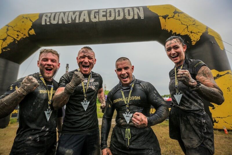 cztery osoby na mecie runmageddonu z medalami Zawodnicy runmageddonu z medalami